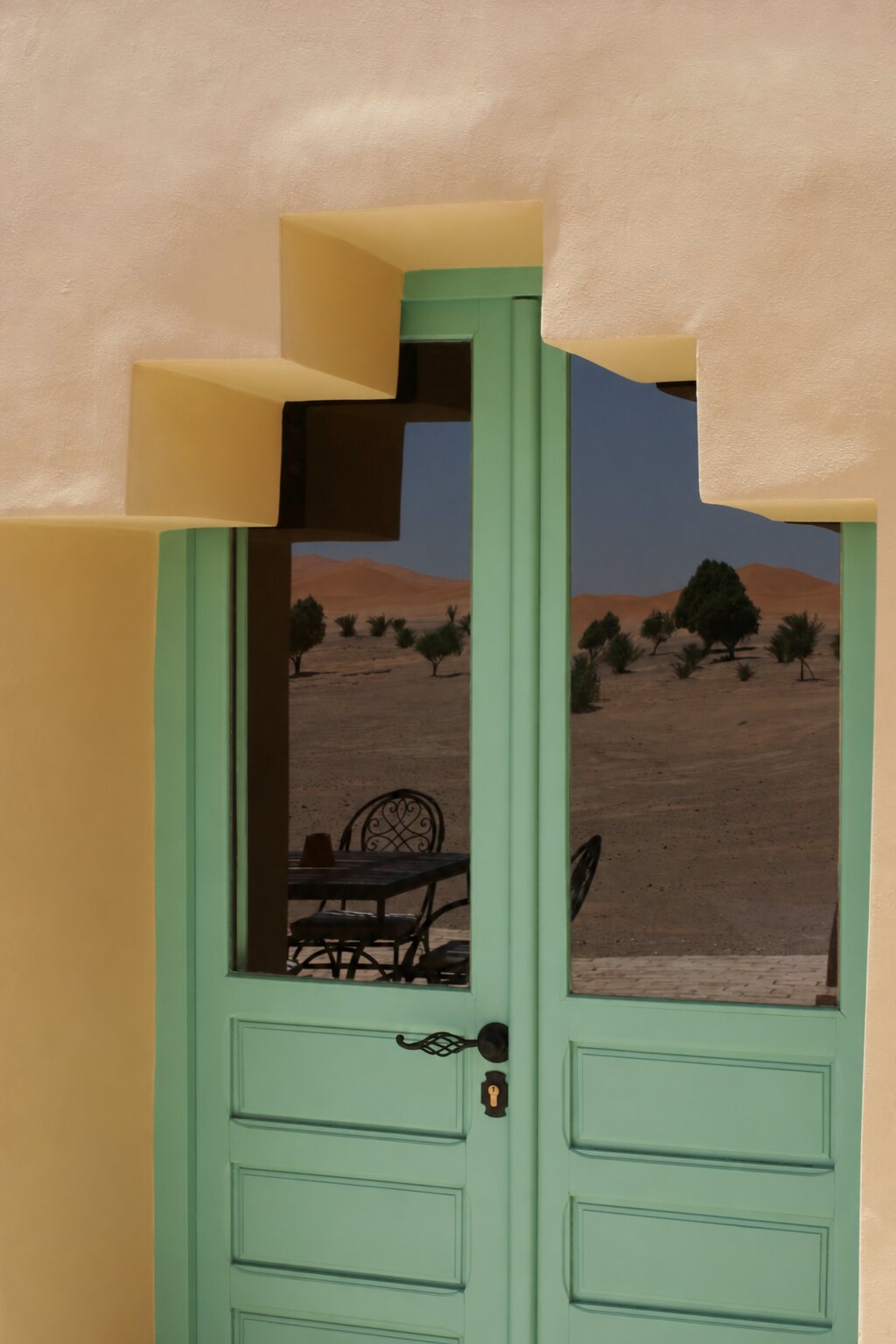 Green door in the courtyard of Dar el Janoub, family-run hotel in Merzouga