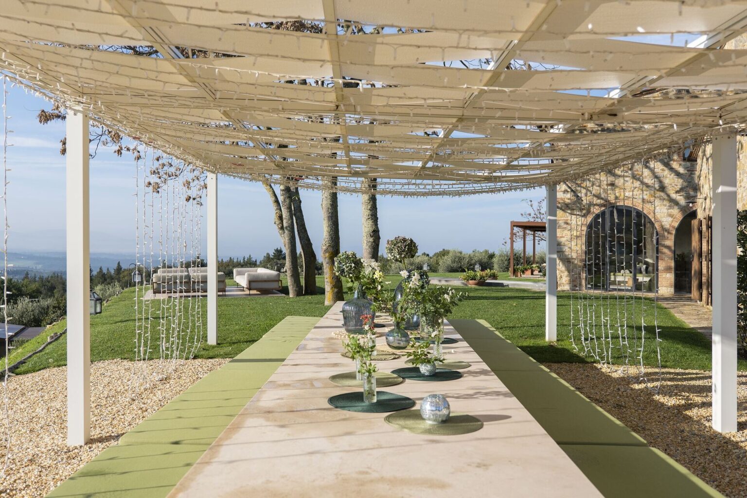 Pergola with dining table in the gardens of Il Cellese, Tuscany