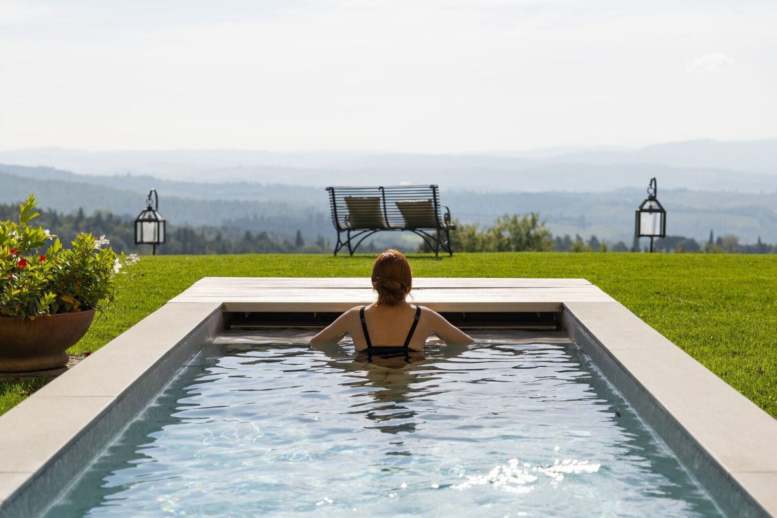 Woman relaxing in the outdoor pool at Il Cellese, Tuscany