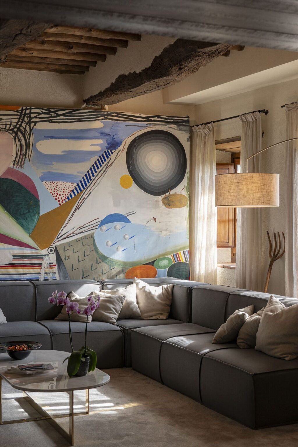 Living room with artwork and fireplace at Il Cellese, Tuscany